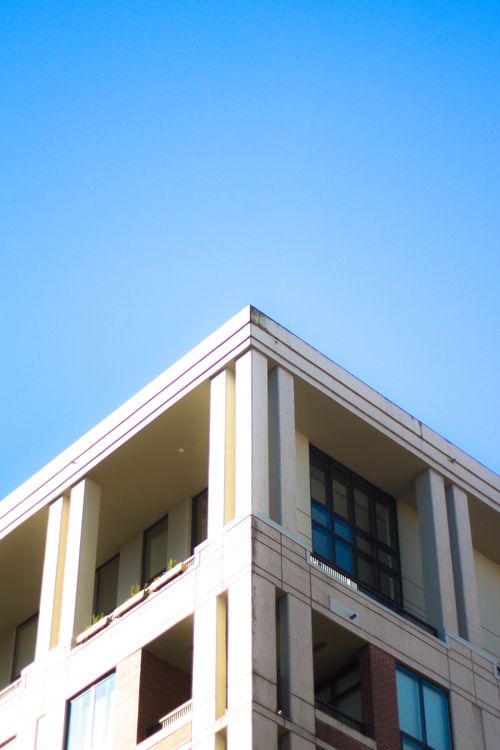 Free Low angle view of a modern building corner in Vancouver, under a clear blue sky. Stock Photo