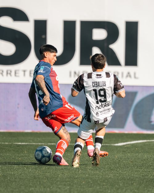 Free Two soccer players in action during a tackle on the field under bright daylight. Stock Photo