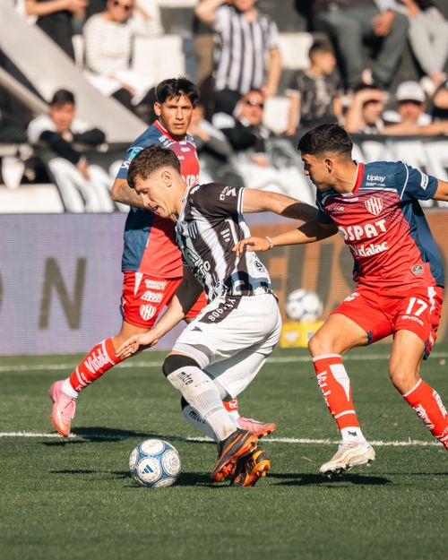 Free Soccer players in action during a competitive match showcasing skills and teamwork on the field. Stock Photo