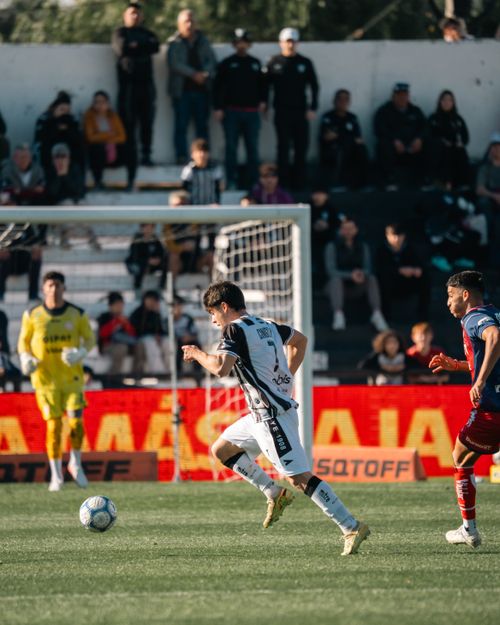 Free Action-packed soccer match with players in motion and spectator background. Stock Photo