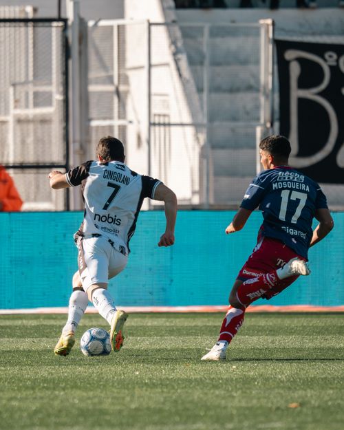 Free Action-packed soccer match with two players vying for control of the ball on the field. Stock Photo