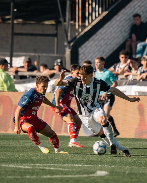 Free Dynamic soccer match scene with two players competing for the ball on a sunny day. Stock Photo