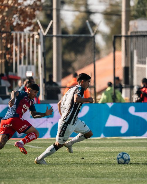 Free Two soccer players in action during an intense match on a sunny day. Stock Photo