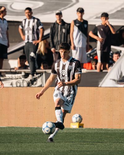 Player in striped kit striking the ball — photo by Mateo Franciosi on Pexels