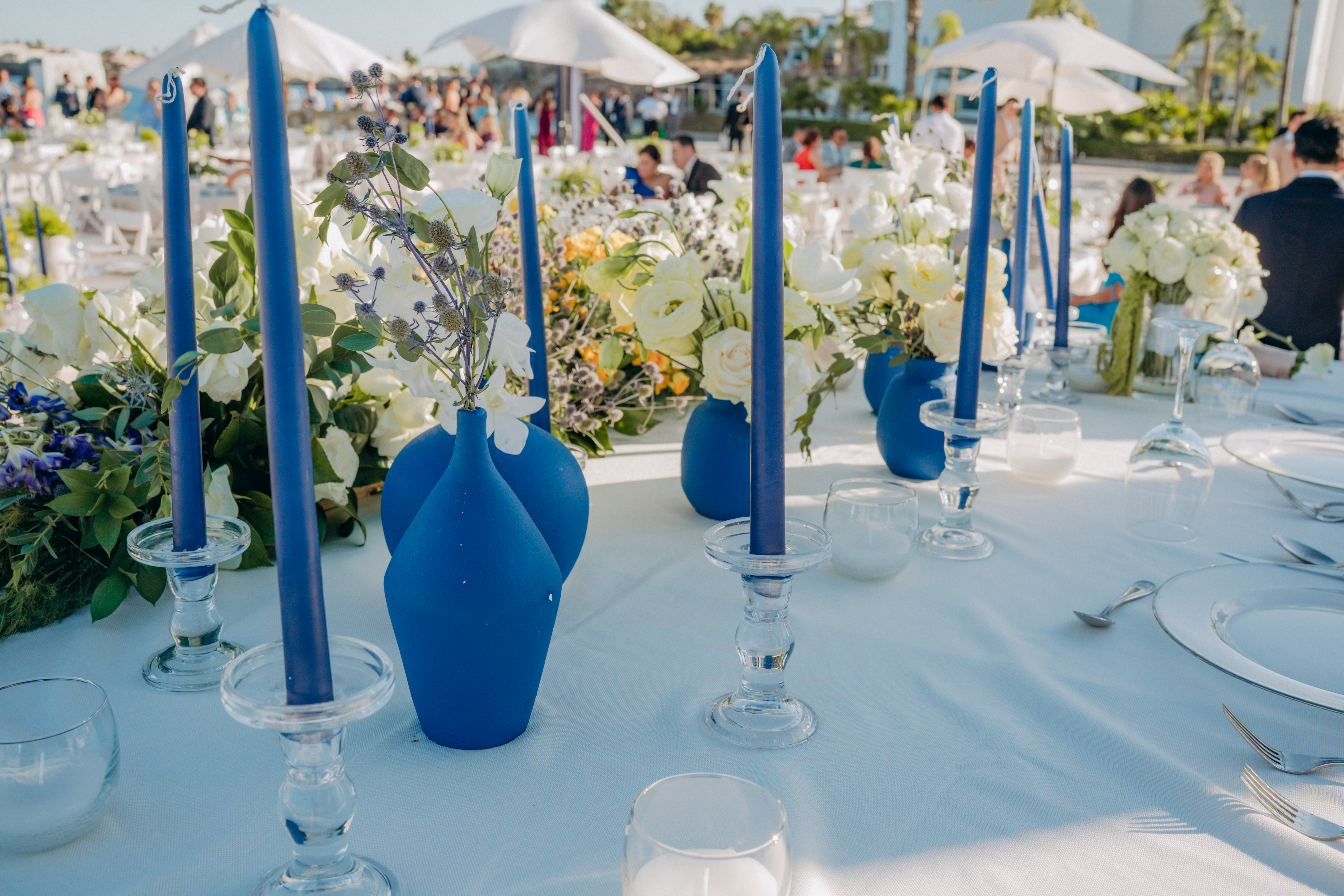 Elegant outdoor event table setup with linens, candles, and floral centerpieces for a San Antonio reception
