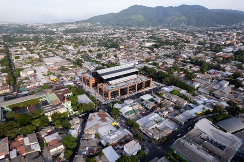 Free Aerial photograph showcasing the bustling urban landscape of San Salvador, El Salvador against mountainous backdrop. Stock Photo