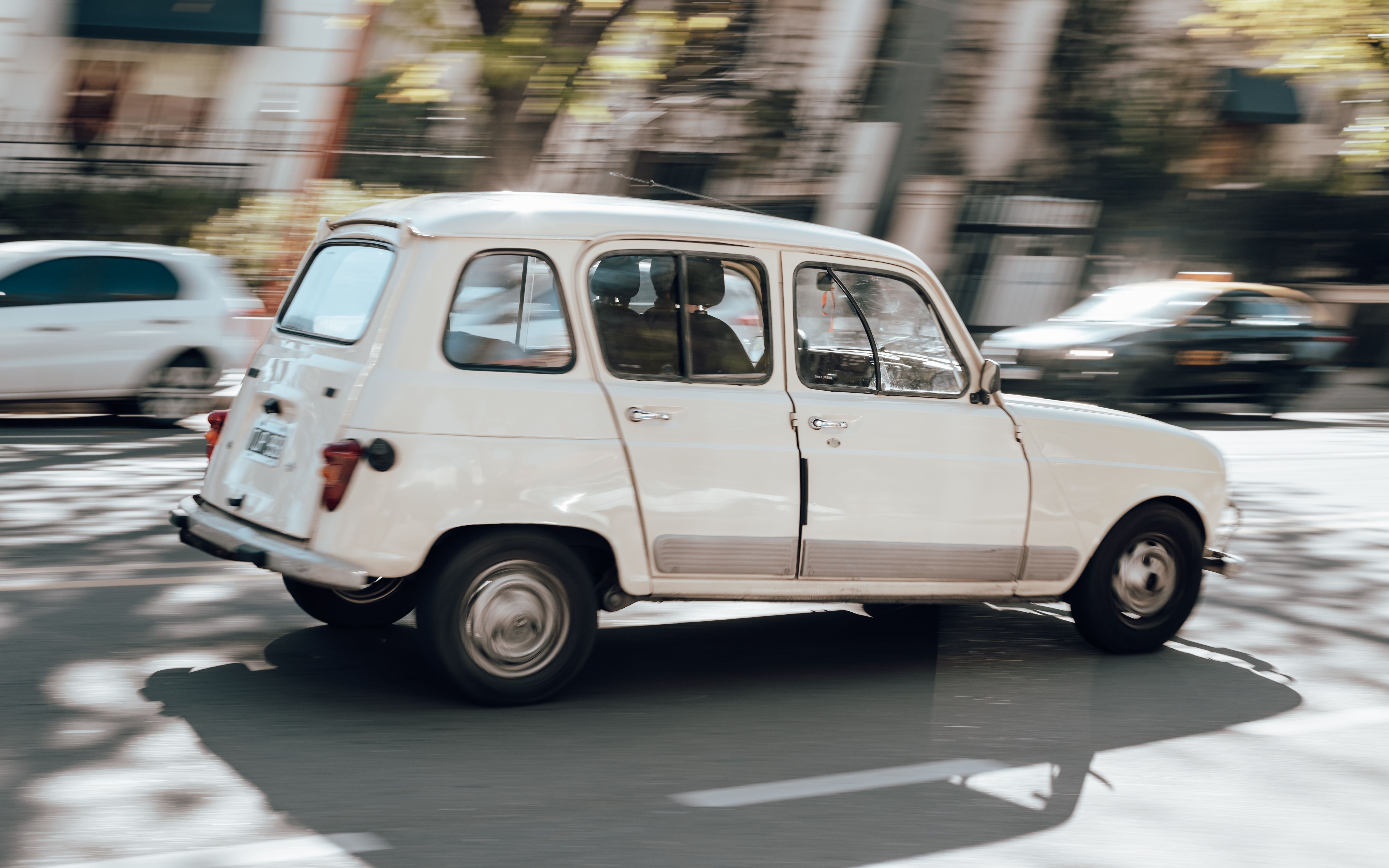Vintage Renault 4 car driving through sunny streets in Mendoza, Argentina