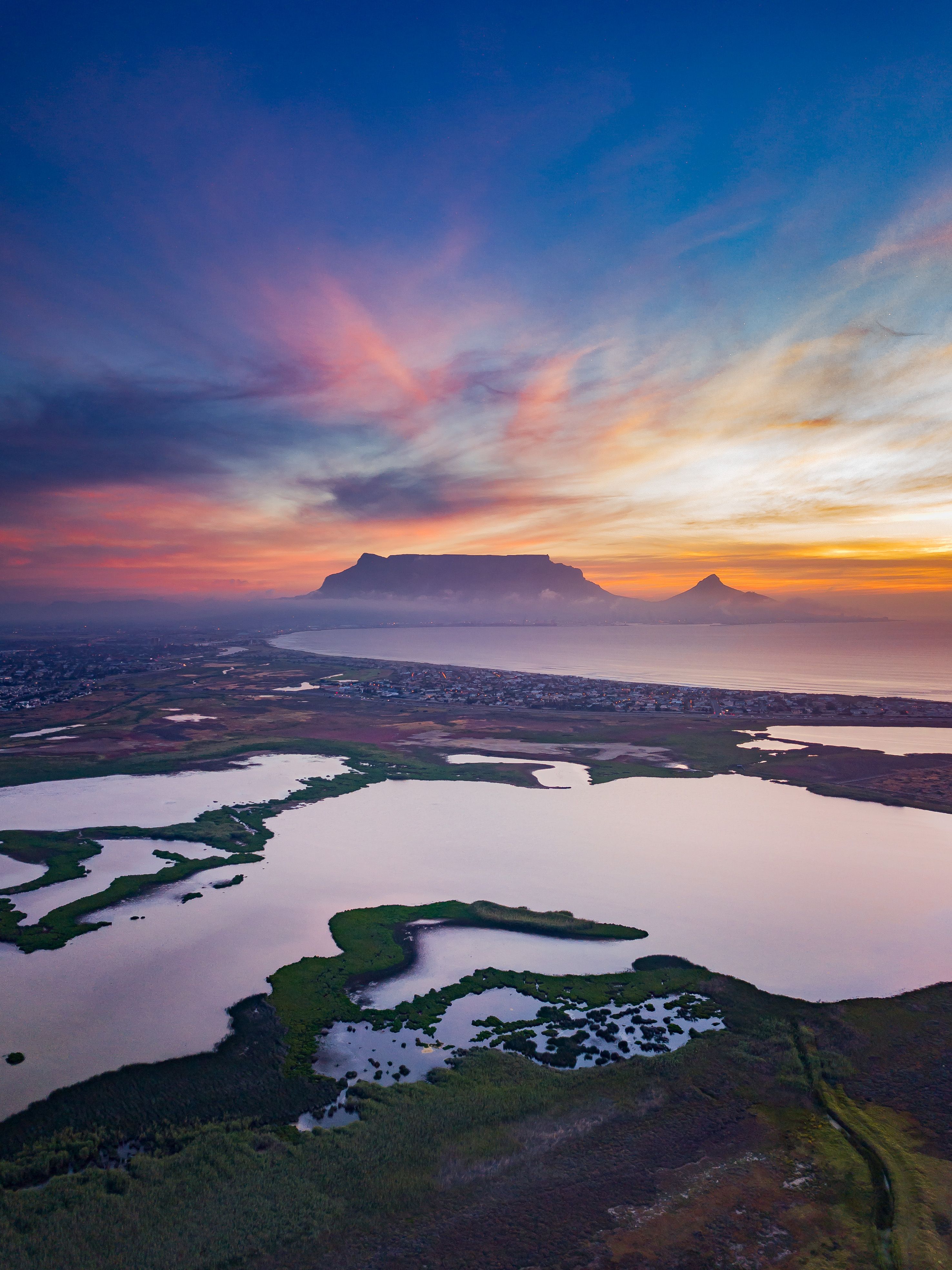 Amazing sunset over mountainous landscape with lakes and coastline ...