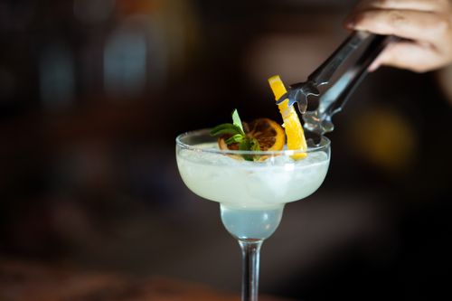 Free Vibrant cocktail with fresh citrus garnishing, perfect for summer refreshment. Stock Photo
