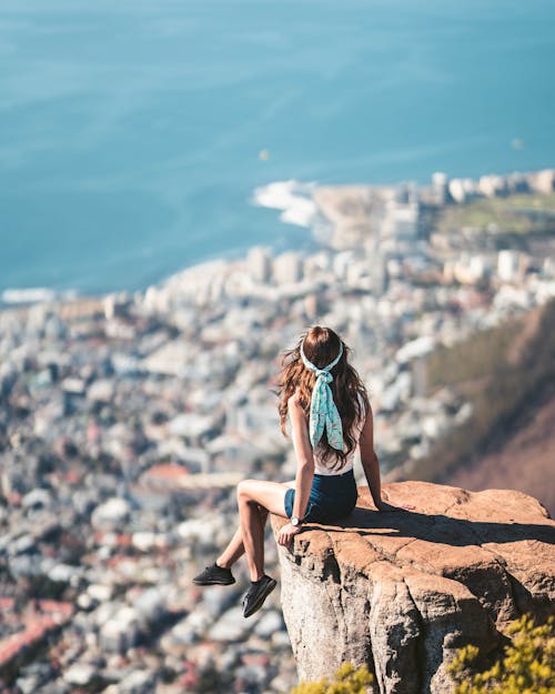 Free Woman iSitting On The Edge Of A Cliff Stock Photo