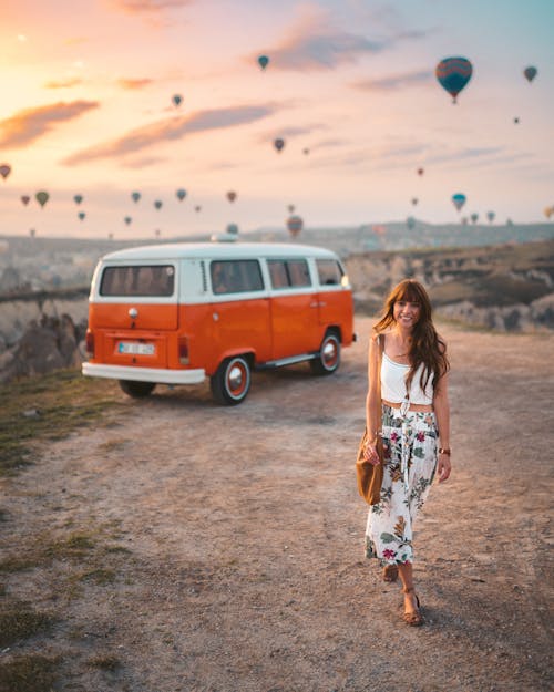 Free Woman In White Top And Floral Skirt Near Vehicle Stock Photo