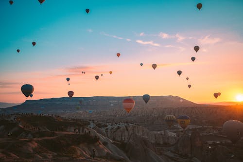 Free Hot Air Balloons Flying over the Mountains Stock Photo