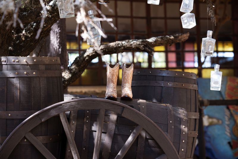 Rustic cowboy boots and western party decor display