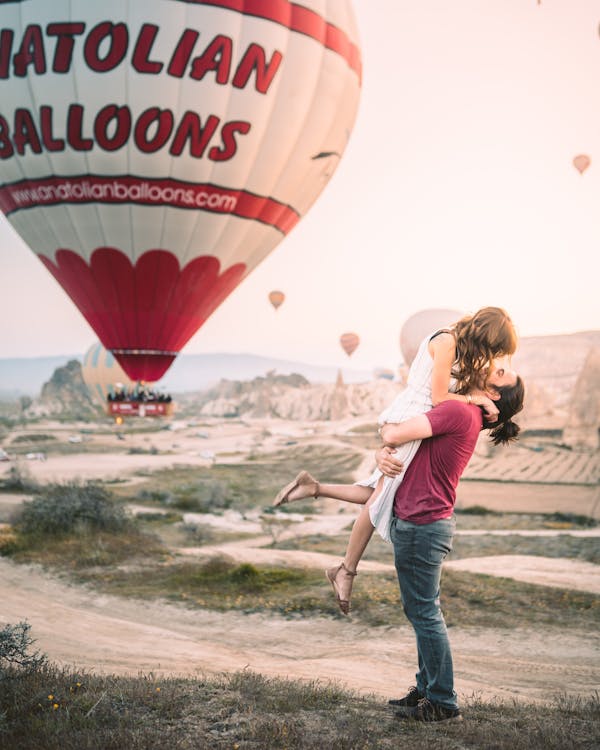 A Happy Couple With Hot Air Balloon On Background
