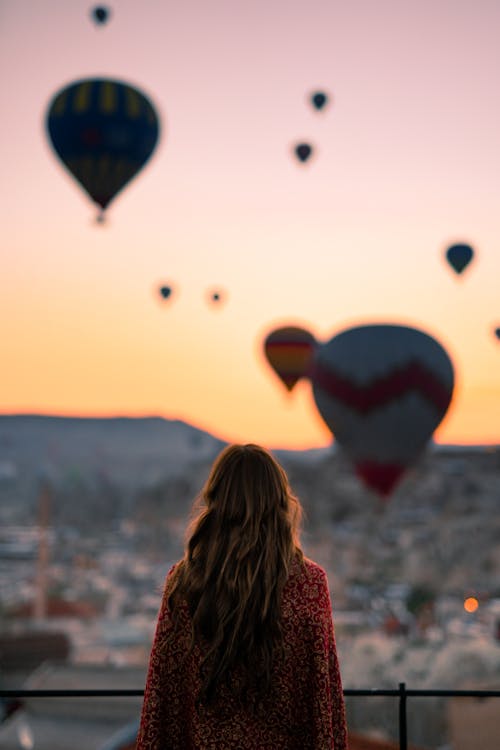 Woman Looking At Hot Air Balloons