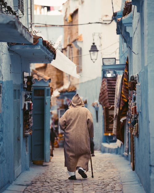 Free Photo Of Person Walking On Alley Stock Photo