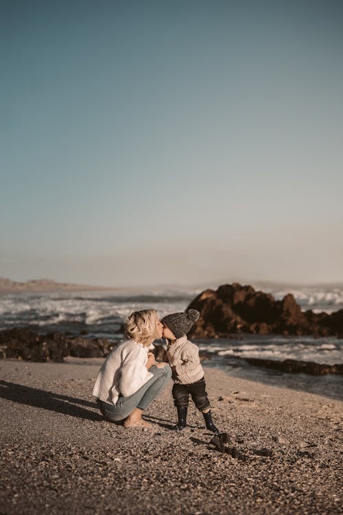 Free Photo Of Woman Kissing Toddler Stock Photo