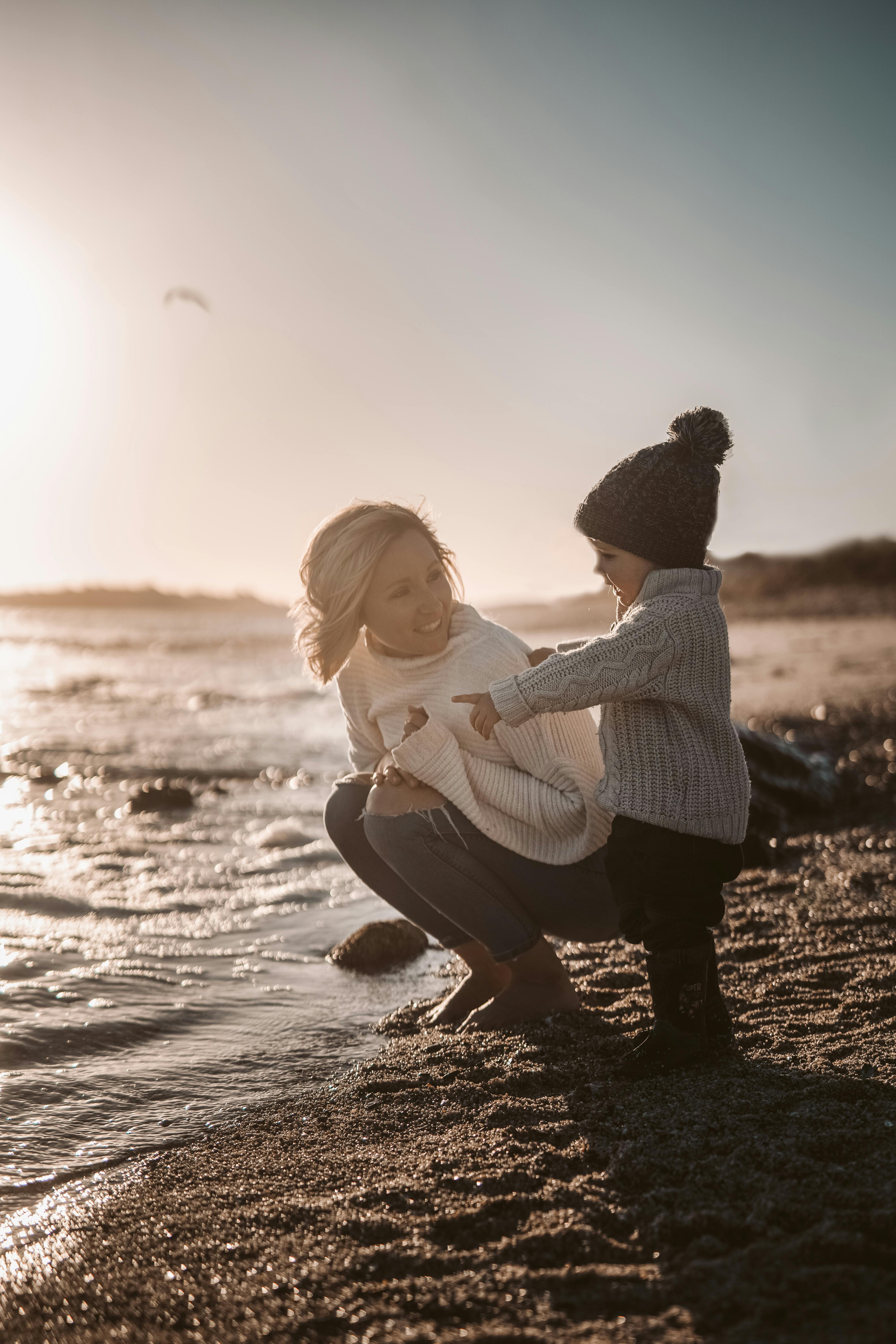 photo of woman beside child