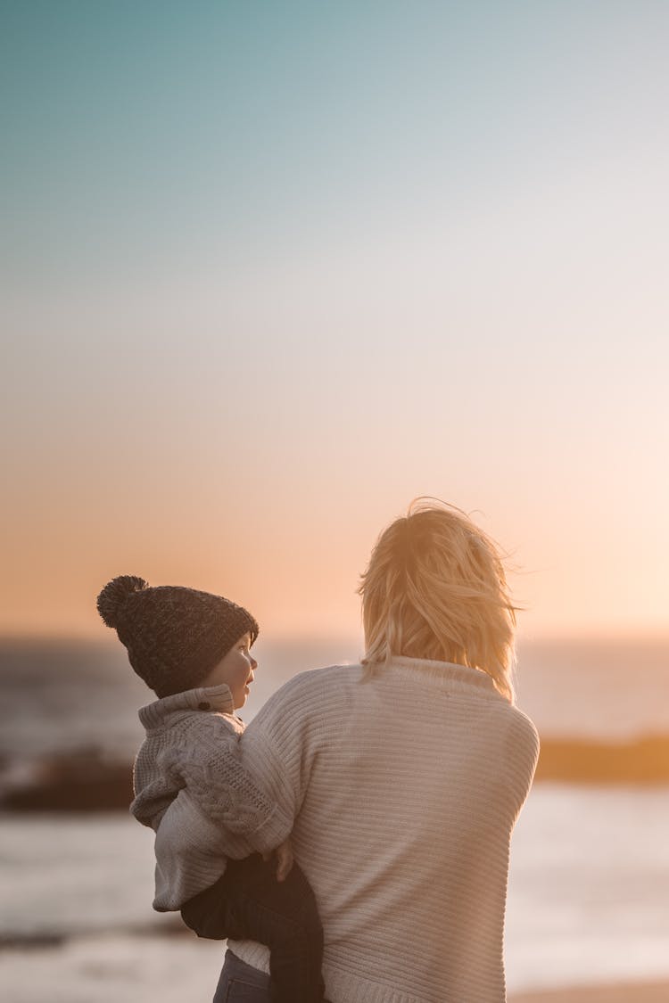 Photo Of Woman Carrying Child 