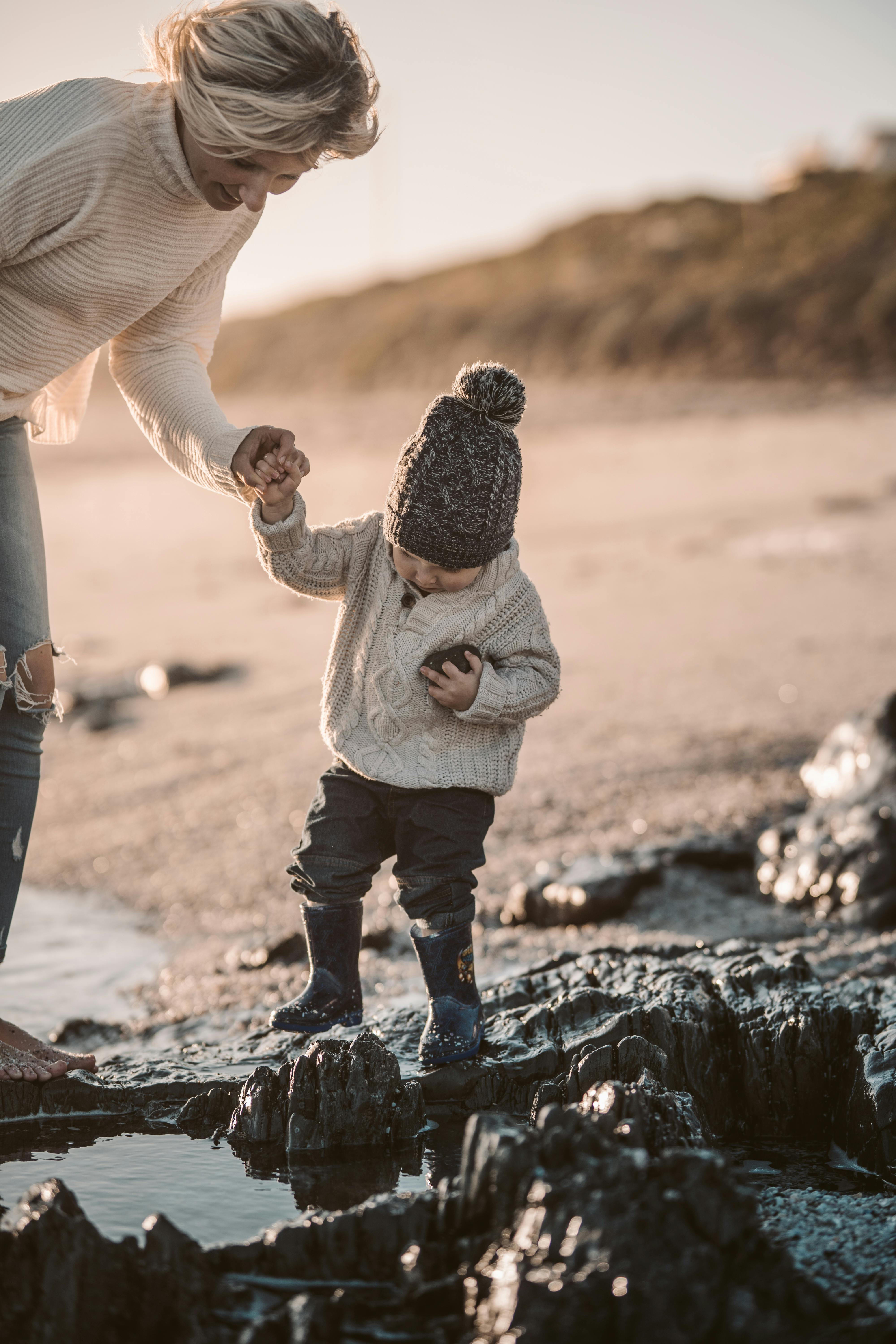 photo of woman holding toddler