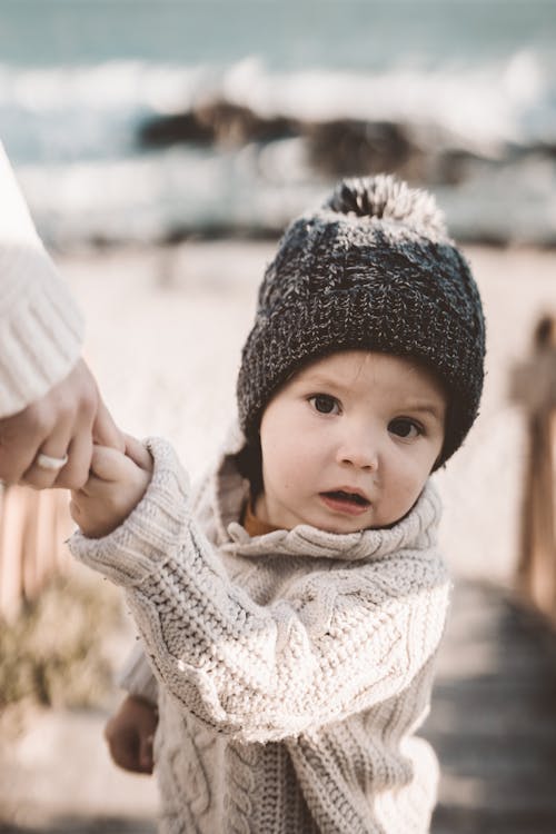 Photo Of Toddler Wearing Knitted Sweater