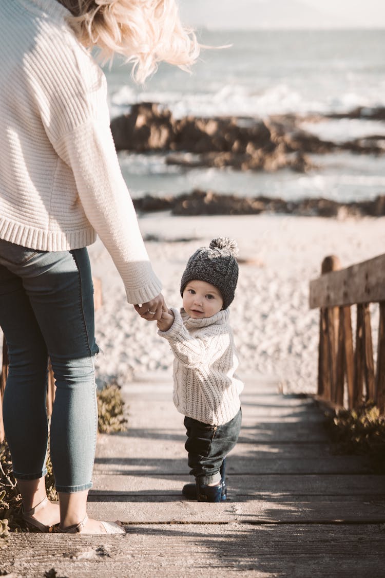 Photo Of Person Holding Toddler