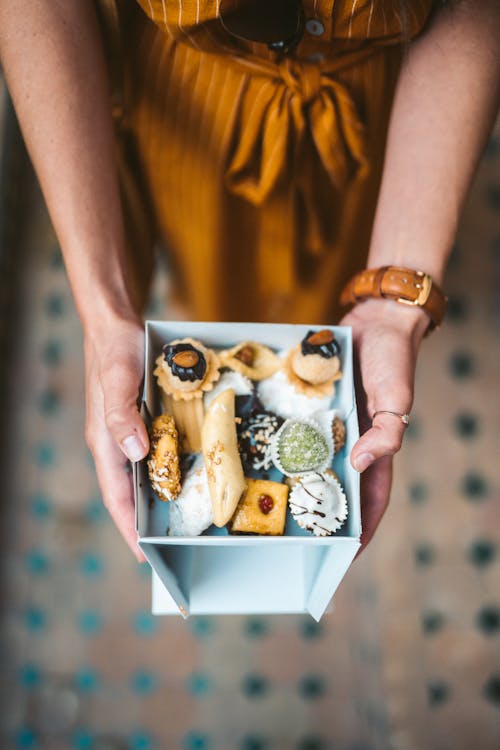 Person Holding Box With Pastries