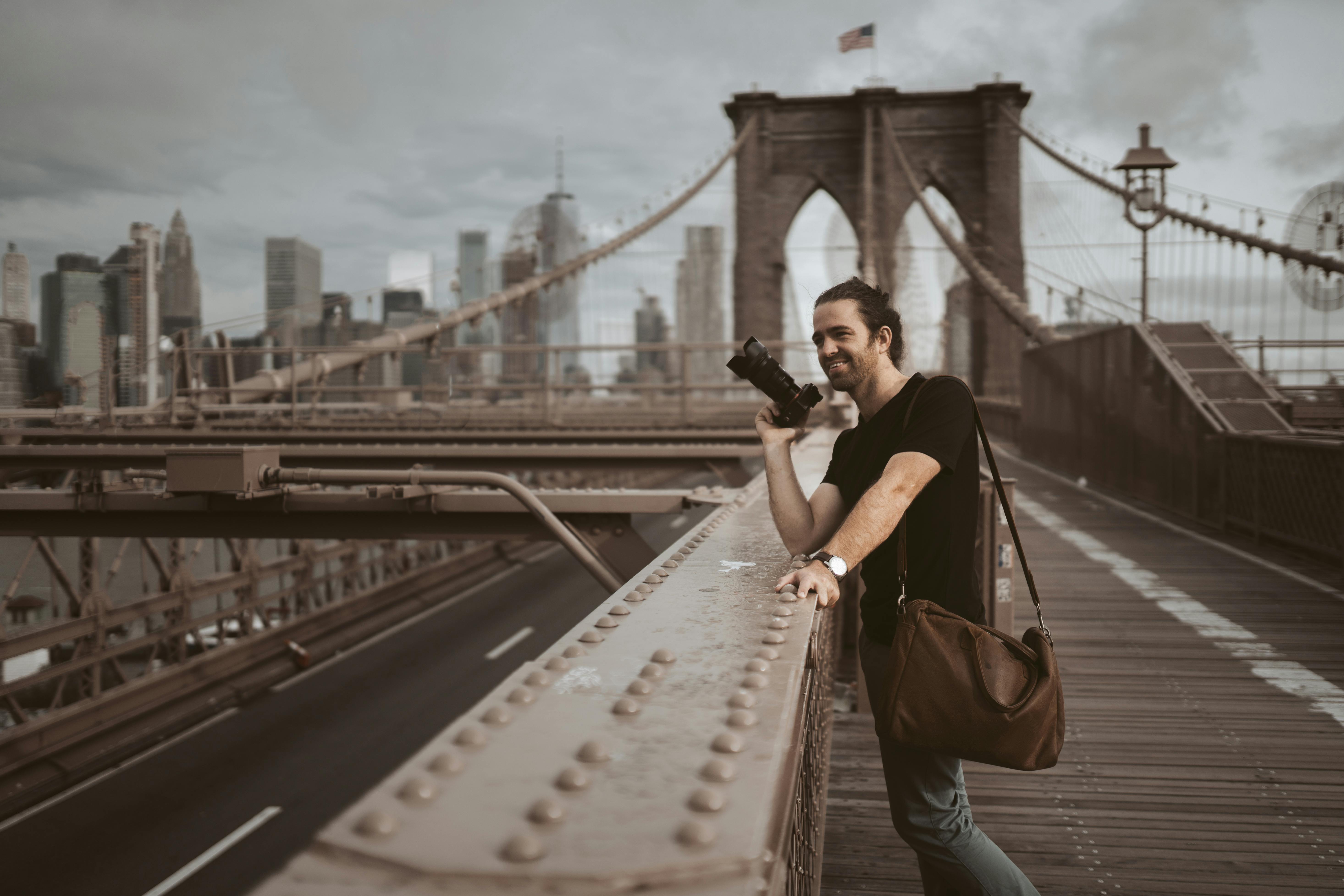 photo of man holding black camera