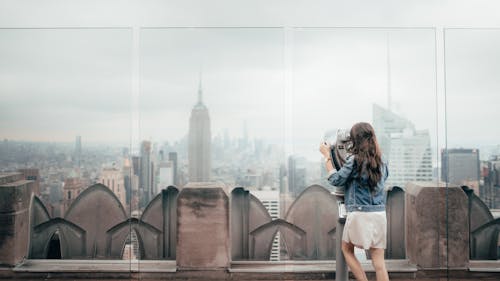 Free Woman In Blue Denim Jacket Standing On Top Of Building Stock Photo
