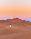Photo Of Person Walking On Dessert
