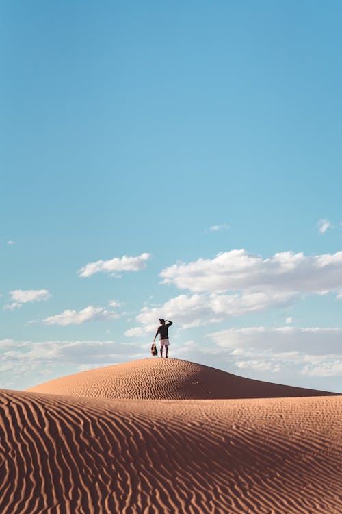Man Standing On Sand Dune