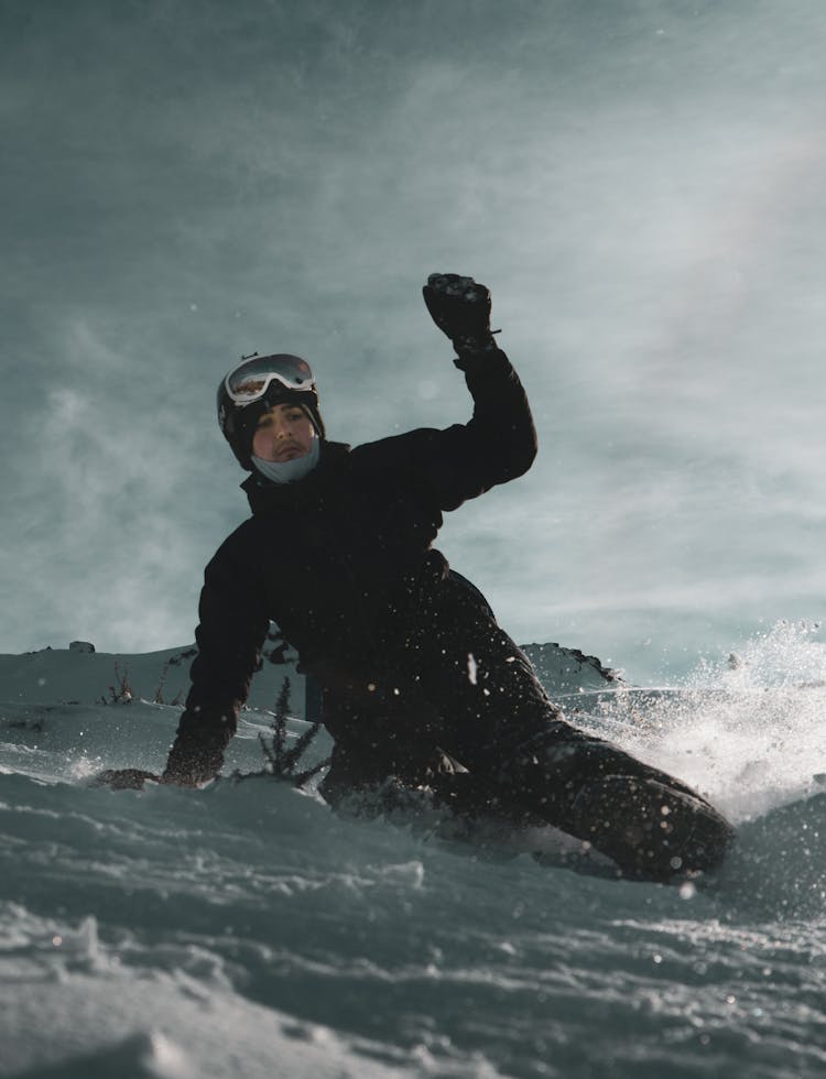 Man Sliding Down A Snow