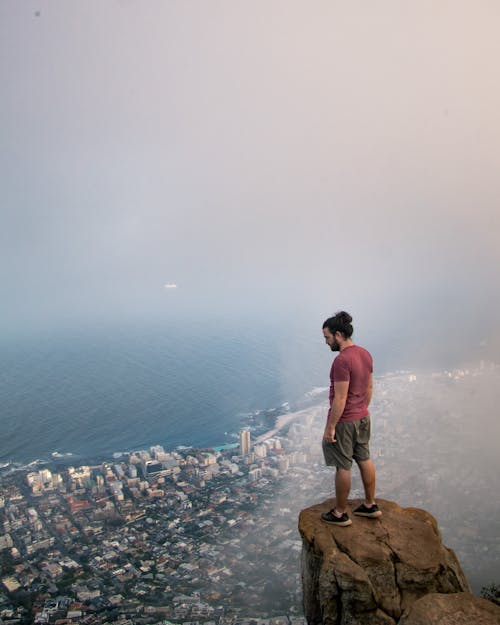 Photo Of Person Standing On A Cliff