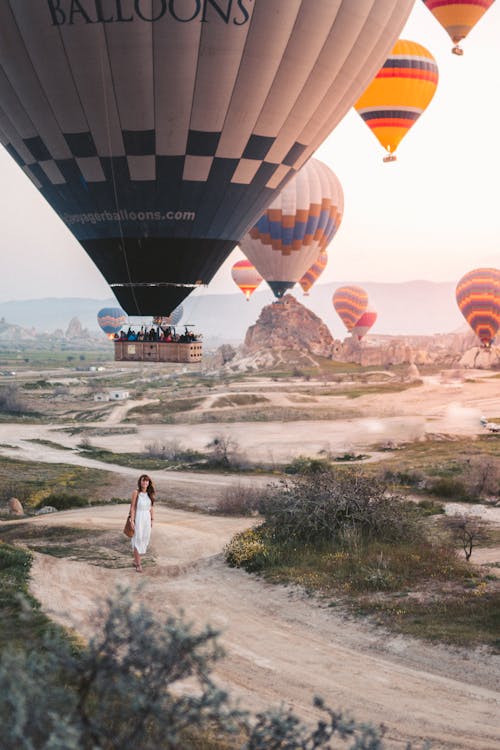 Free Woman Standing Under Hot Air Balloons Stock Photo