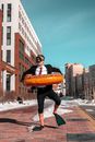 Man in swimming circle and mask walking on street
