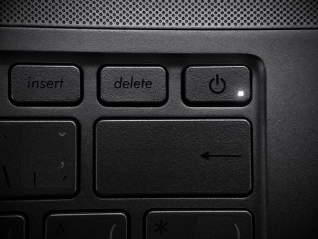 Detailed close-up of a laptop keyboard highlighting the power button and keys.