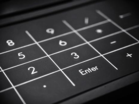 Black and white image of a numeric keypad highlighting the Enter key.