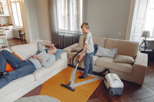 Free Boy Cleaning The Living Room Stock Photo