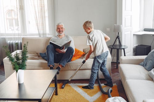 Photo Of Boy Cleaning The Carpet