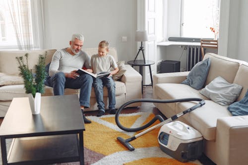 Photo Of People Sitting On Sofa