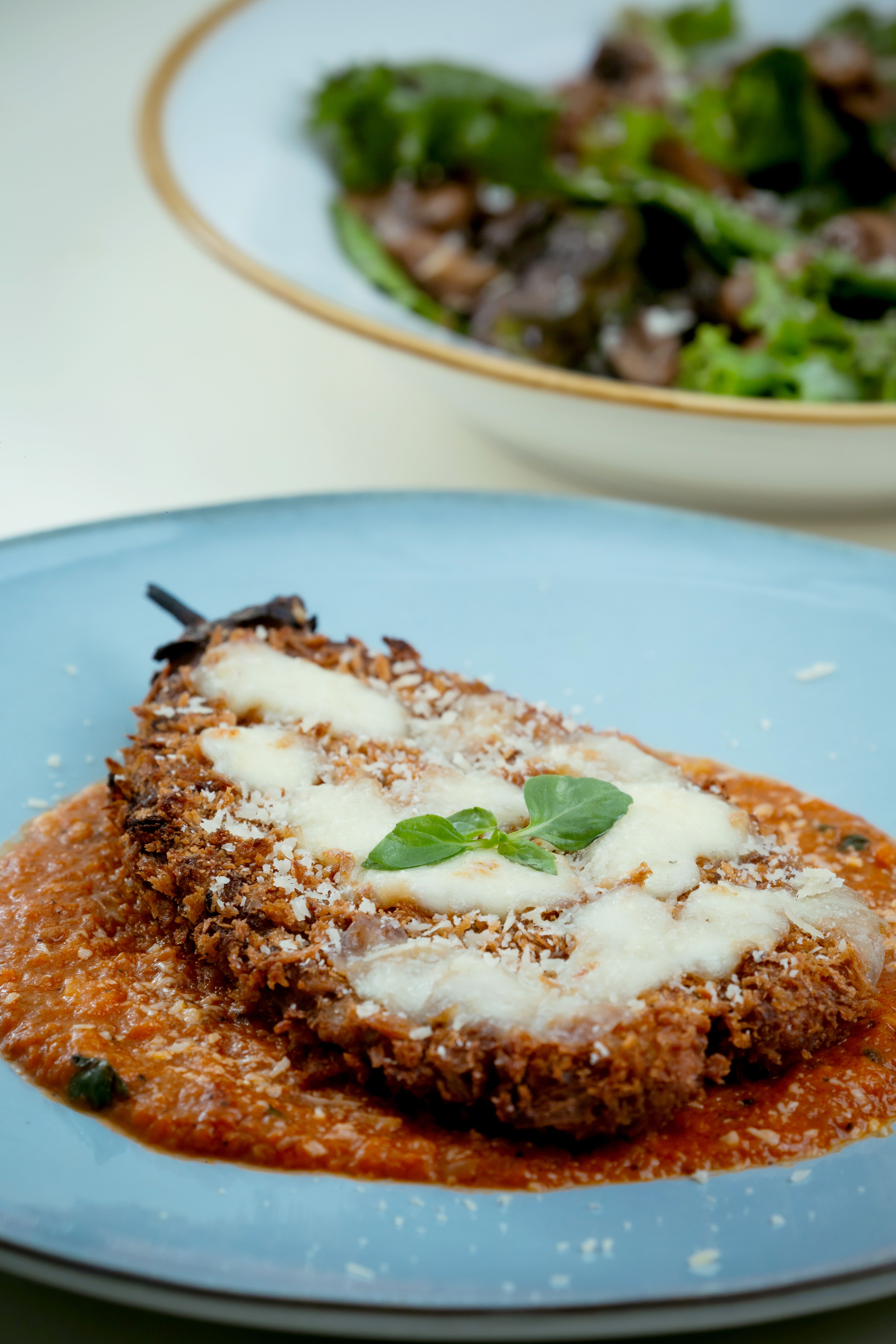Layers of crisp breaded eggplant, marinara, and melted mozzarella and Parmesan, baked until bubbling.