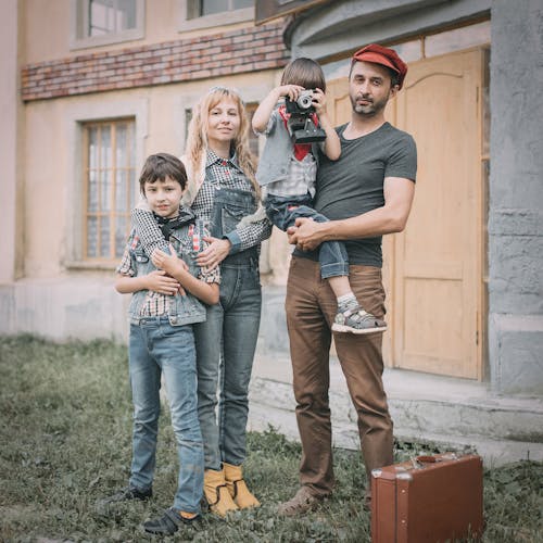 Free Man And Woman Holding Their Children Stock Photo