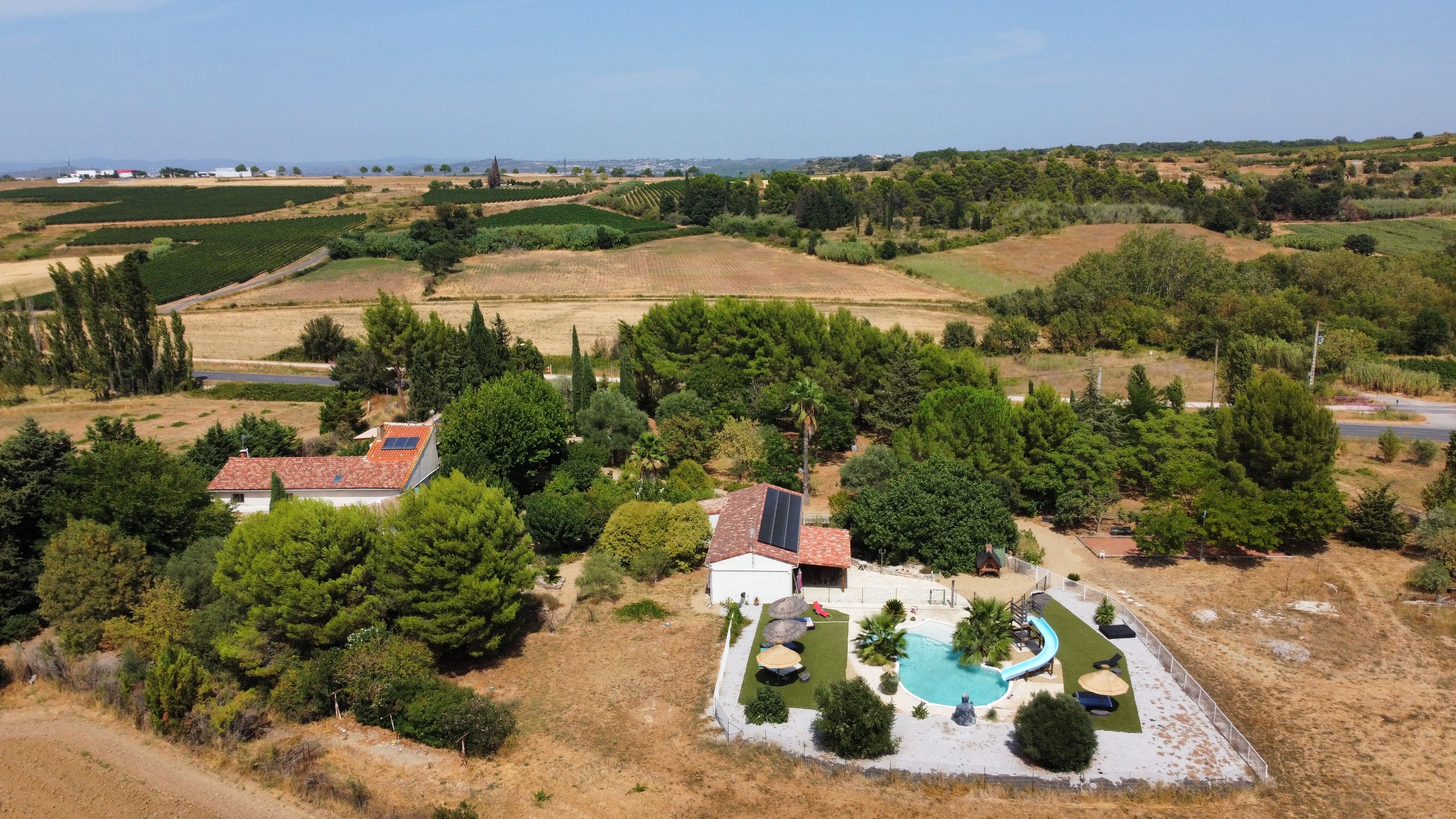 Aerial photograph of a countryside villa with lush greenery and swimming pool. - Photo by Philippe WEICKMANN on Pexels