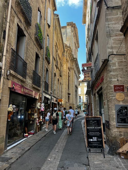 Free Crowded European street with historic architecture and shops on a summer day. Stock Photo