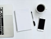 Photo Of Laptop Beside Notebook