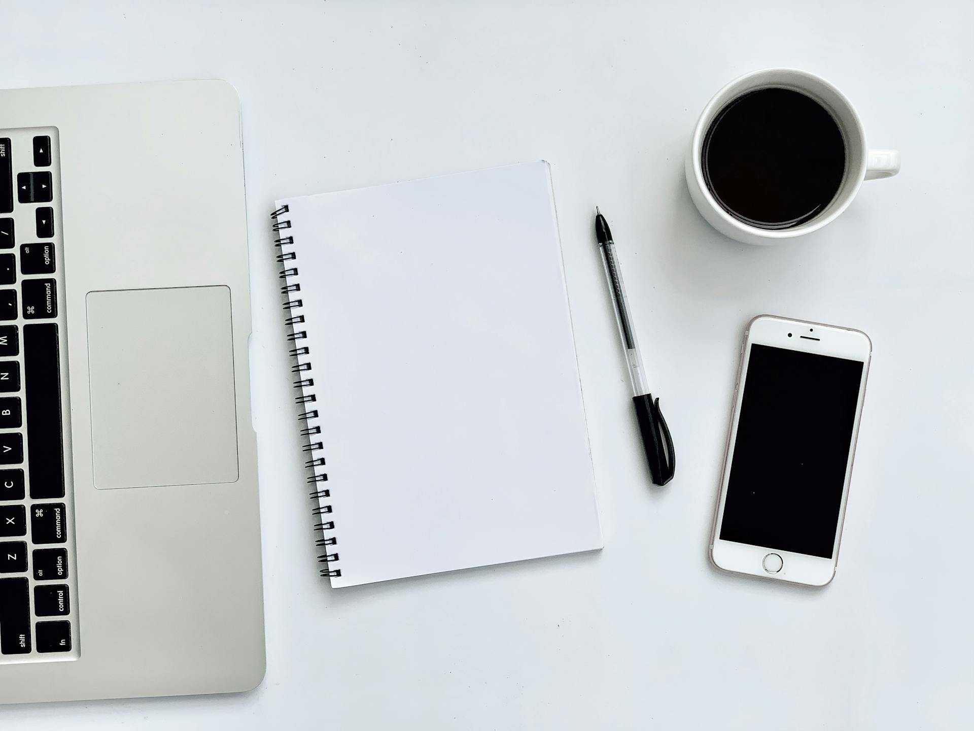 Photo Of Laptop Beside Notebook