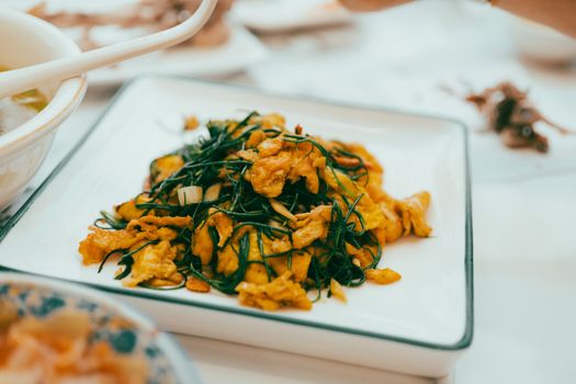 A plate of vibrant stir-fried vegetables and eggs, ideal for Asian cuisine enthusiasts.