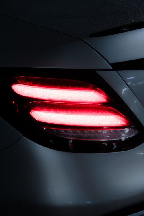 Free Stylish red taillight of a Mercedes-Benz car glowing at night in Amman, Jordan. Stock Photo