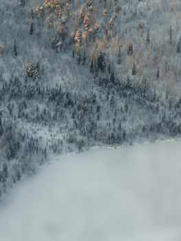 Aerial view of snow-covered forest in Murmansk, Russia during winter.