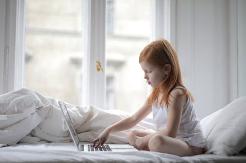 Photo Of Child Using Laptop